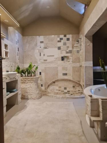 a bathroom with a tub and a sink at Rockscape in Sandown