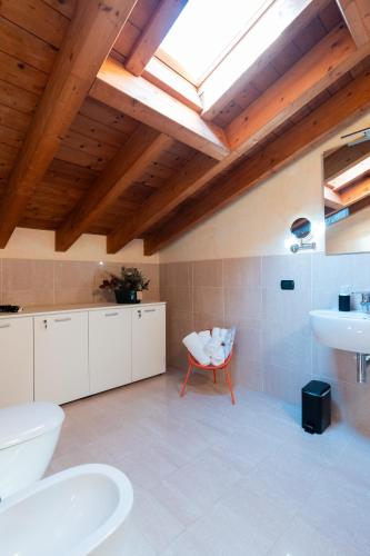 a bathroom with a toilet and a sink and a skylight at Cortevecchia 59 in Ferrara