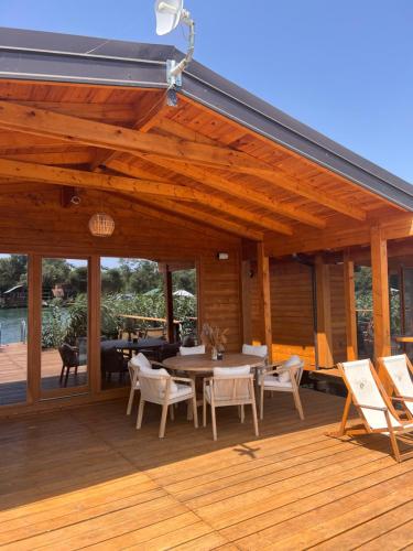 a wooden patio with a table and chairs on a deck at GOLD FISH in Gornji Štoj