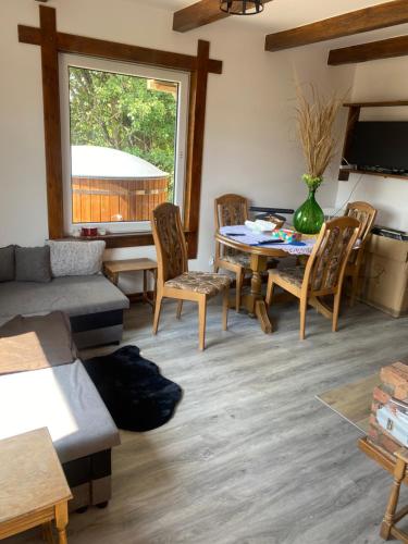 a living room with a table and chairs at Natura Dom Iwona Przybysz in Kaplityny