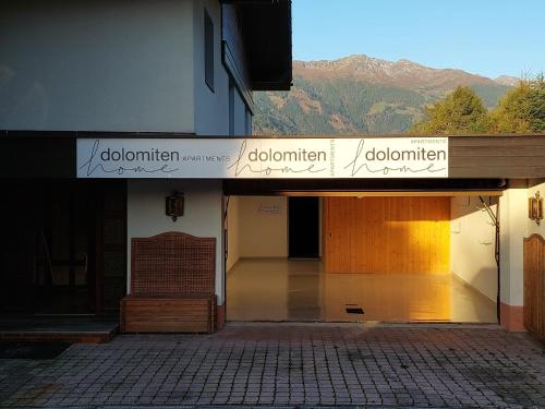 a building with a sign that reads donationhibition on it at Dolomitenhome Apartments in Patriasdorf