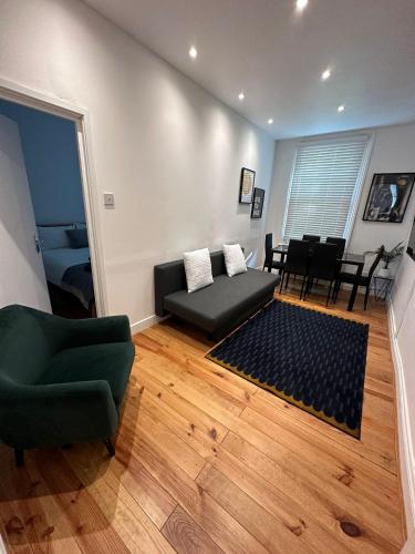 a living room with a couch and a chair at Notting Hill Guest Flat in Ealing