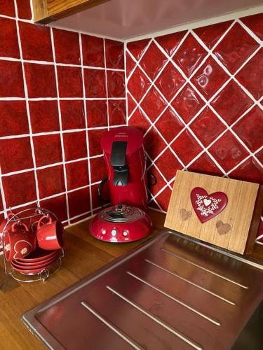 a kitchen counter with a red toaster and a cutting board at Appartement pra loup 1600 4pers in Uvernet-Fours