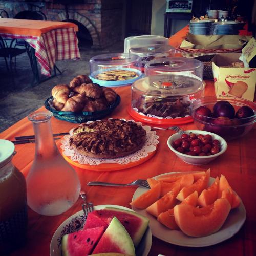 a table topped with plates of food and fruit at Agriturismo Palazzo Bandino - Wine cellar, on reservation restaurant and spa in Chianciano Terme