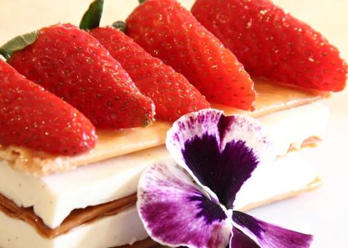 a cake with strawberries on top of it at Exmoor White Horse Inn in Exford