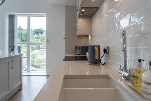 a kitchen with a sink and a counter top at The Sidings, Luxury Penthouse, Haworth in Haworth