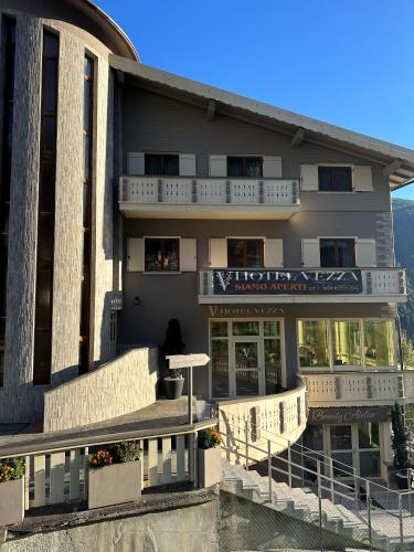 a building with a sign on the side of it at Hotel Vezza Alpine Lodge & Spa in Vezza dʼOglio
