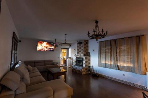 a living room with a couch and a fireplace at Casa Rural El Abuelo Mauri 4* En Toledo in Mascaraque