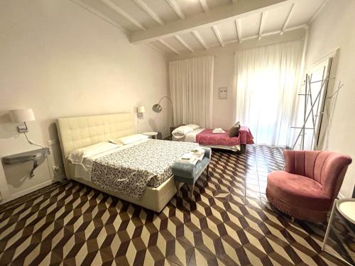 a bedroom with a bed and a chair in a room at Allegra Toscana - Affittacamere Guest house Arezzo in Arezzo
