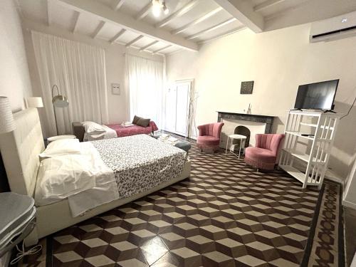a bedroom with a bed and a tv and a fireplace at Allegra Toscana - Affittacamere Guest house Arezzo in Arezzo