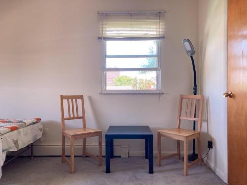 a room with two chairs and a table and a window at Cozy Room in Fort Lee in Fort Lee
