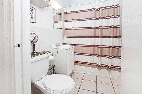 a bathroom with a toilet and a shower curtain at great studio apt new york city in New York