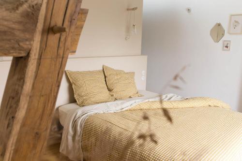 a bed with two pillows on it in a room at Maison d'hôtes le détour en pleine nature in Channay-sur-Lathan