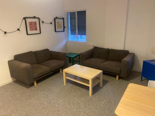 a living room with two couches and a coffee table at Sheffield City Centre - Westhill House Apartments in Sheffield