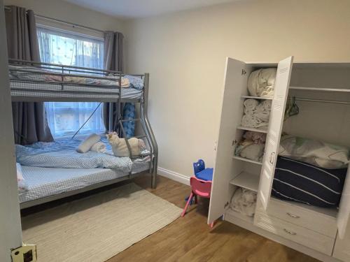 a bedroom with two bunk beds and a window at Fresh Apartment & Parking in London