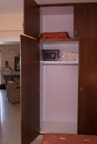 a refrigerator with a microwave sitting on top of it at Kotzias Beach Apartments in Pissouri