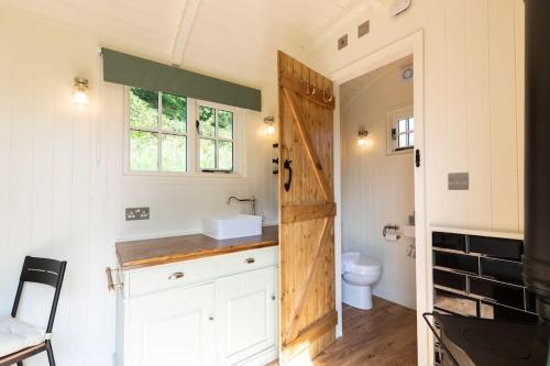a small bathroom with a sink and a toilet at Dilly Hill Den in Stanhope