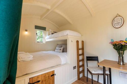 a bedroom with a bunk bed and a desk at Dilly Hill Den in Stanhope