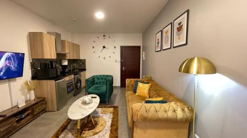 a living room with a couch and a table at Accra Luxury apartments at Oasis Park Residences in Accra