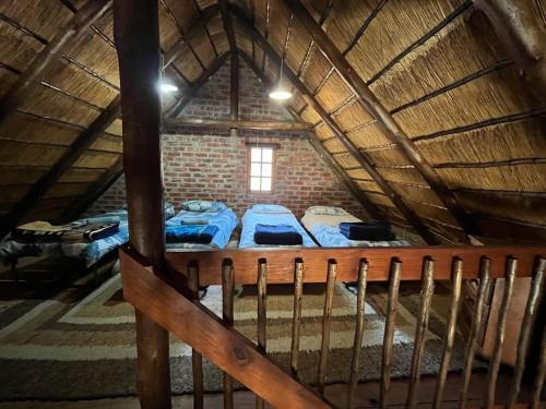 a room with three beds in a attic at Schoemanshof in Potchefstroom