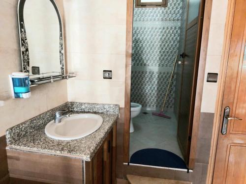 een badkamer met een wastafel en een douche bij Gite Rahhaoui Simo in Kasba des Aït Moussa