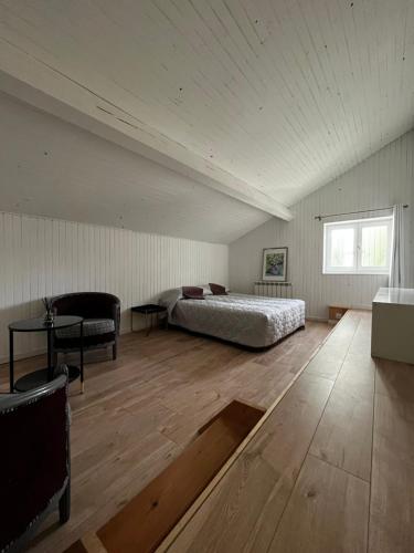een slaapkamer met een bed en een tafel in een kamer bij Petite maison dans le beaujolais 