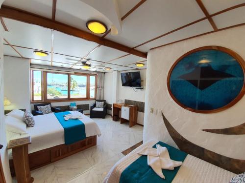 een grote kamer met een bed en een bank bij Casa Ocean Pier in Puerto Ayora