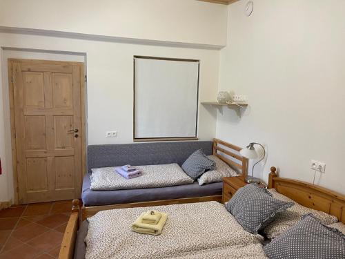 a room with two beds and a window and a door at Chata Betty Kvilda in Kvilda