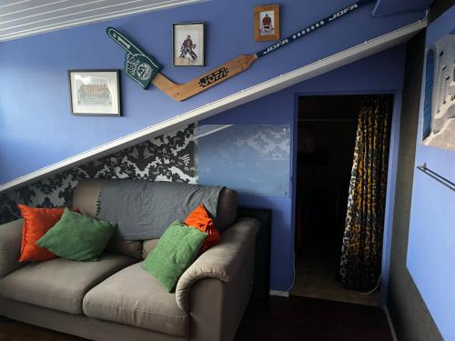 a living room with a couch and baseball bats on the wall at Nene and Jonas Bed and breakfast in Stockholm
