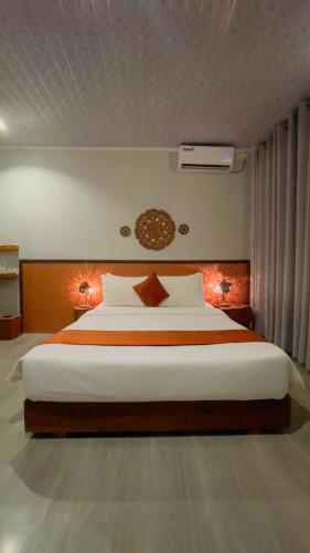 a bedroom with a large bed with two lamps at Sandy Heaven Maldives in Gulhi