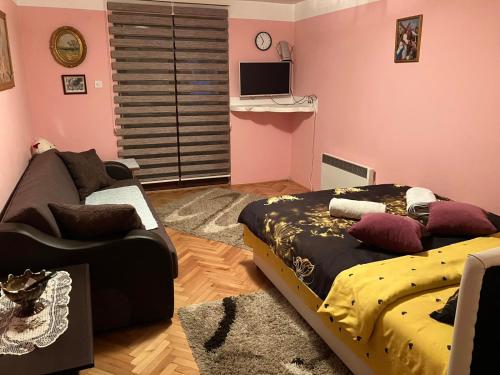 a living room with two beds and a couch at Apartmani Rada in Zlatibor