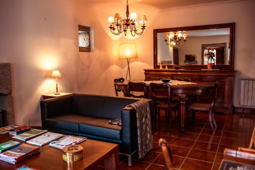 a living room with a couch and a table at Casa Sobreira da Silva - Alojamento Local in Almeida
