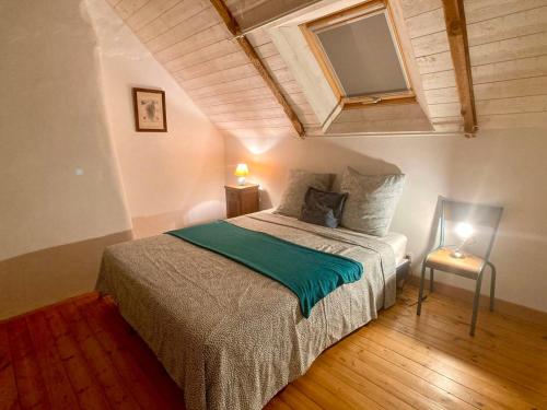 um quarto com uma cama com um cobertor verde em LA MAISON BLEUE,authenticité, nature, simplicité, 2-5 personnes, Moëlan sur Mer em Moëlan-sur-Mer