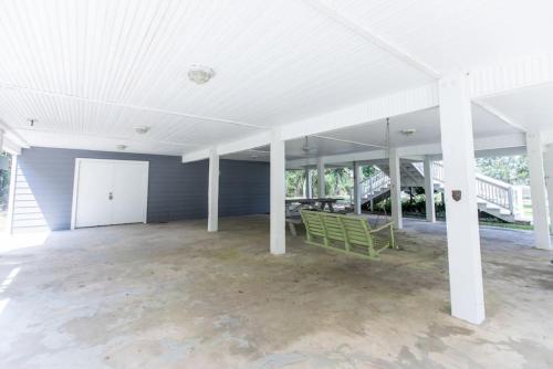 a large empty room with a white ceiling and white columns at Cypress Landing in Pass Christian
