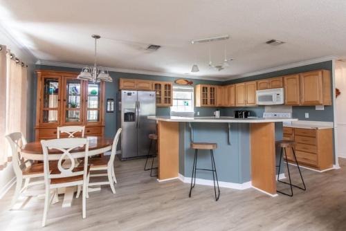 a kitchen and dining room with a table and chairs at Cypress Landing in Pass Christian