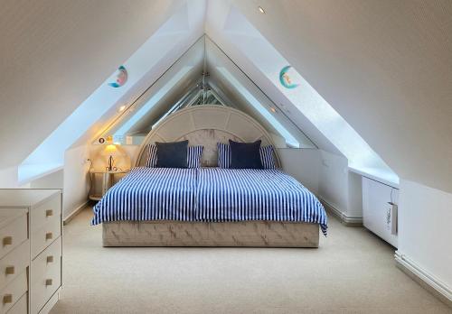 a bedroom with a large bed in a attic at Haus Regina in Timmendorfer Strand