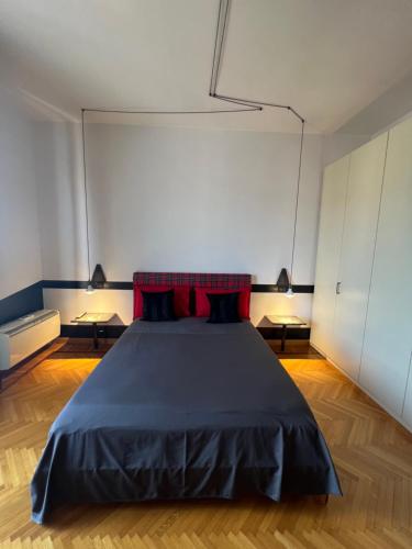 a bedroom with a large bed with red pillows at Alloggio Galileo in Turin