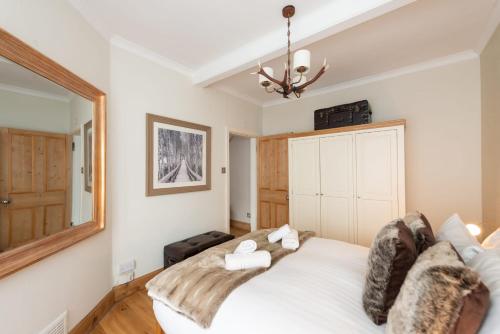 a bedroom with a white bed and a mirror at Charming Grassmarket 1 Bed Castle pad in Edinburgh