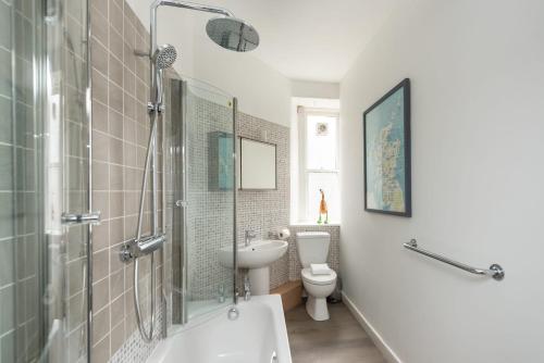 a bathroom with a sink and a toilet and a shower at Charming Grassmarket 1 Bed Castle pad in Edinburgh