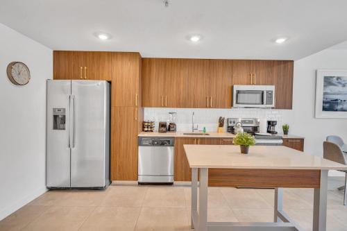 a kitchen with a stainless steel refrigerator and a table at Beautiful Unit with Amazing View & Free Parking in Miami