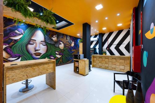 a lobby with a colorful mural on the wall at Mural Living Hotel Manaus in Manaus
