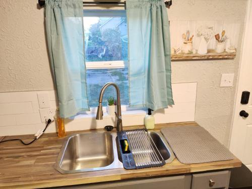 a kitchen counter with a sink and a window at Tranquil Oasis- Private Rooms -Near Downtown Indianapolis in Indianapolis