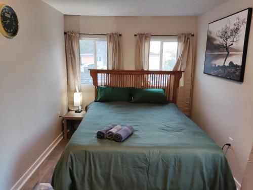 a bedroom with a bed with two towels on it at TRANQUIL OASIS - Private Rooms -Near Downtown Indianapolis in Indianapolis