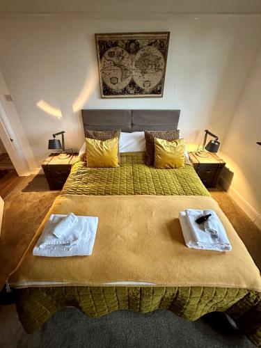 a bedroom with a bed with two towels on it at 3 Bed Ground Floor Apartment - Hot Tub Optional Upgrade in Hythe