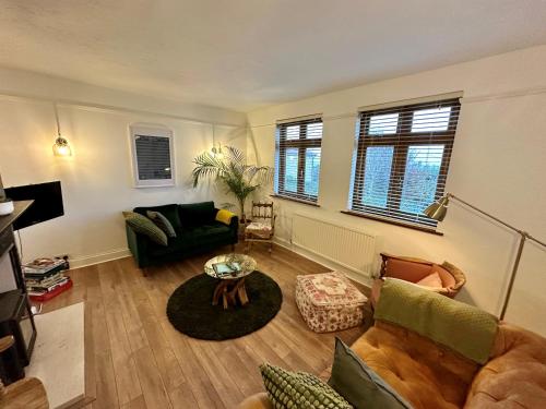 a living room with a couch and a table at 3 Bed Ground Floor Apartment - Hot Tub Optional Upgrade in Hythe
