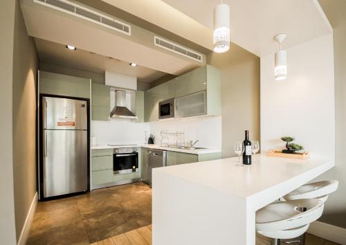 a kitchen with a white counter and a refrigerator at Accra Pearl in City in Accra