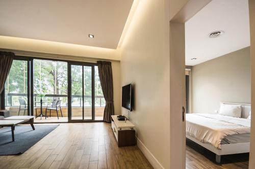 a bedroom with a bed and a sliding glass door at Accra Pearl in City in Accra