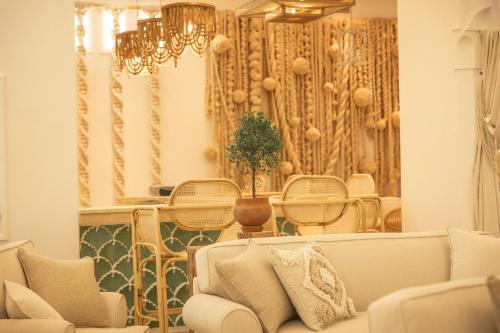 - un salon avec un canapé, une table et des chaises dans l'établissement Les Palmiers Boutique Hôtel & Spa, à Marrakech