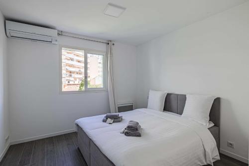 a bedroom with a bed with two bags on it at Beautiful renovated 4P1BR apartment with view on garden in Antibes