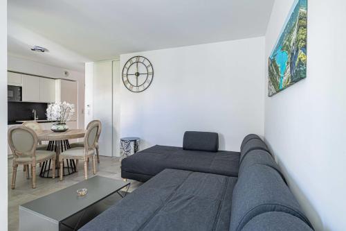 a living room with a couch and a table at Beautiful renovated 4P1BR apartment with view on garden in Antibes